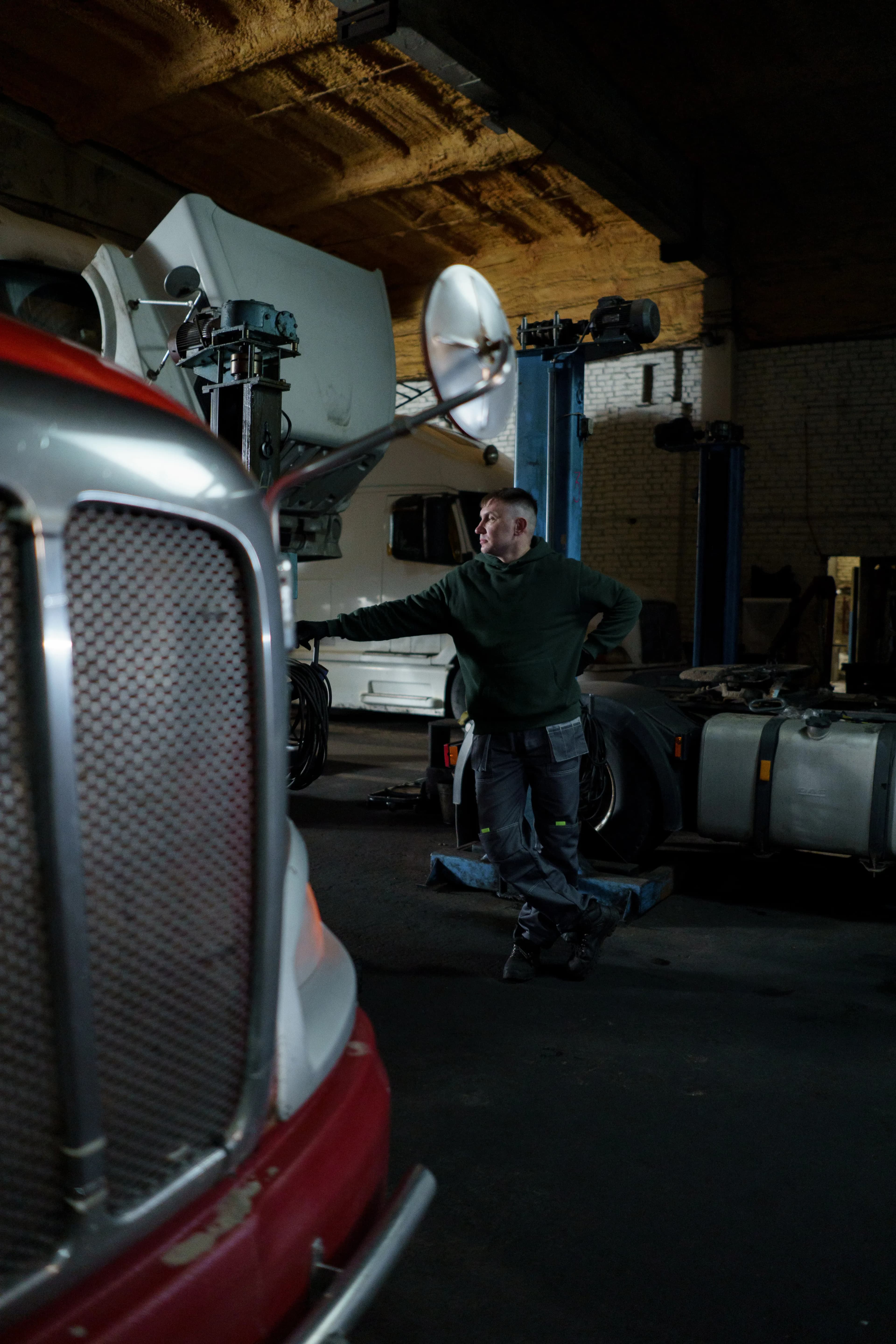 Mechanic working on a heavy-duty semi-truck in a garage